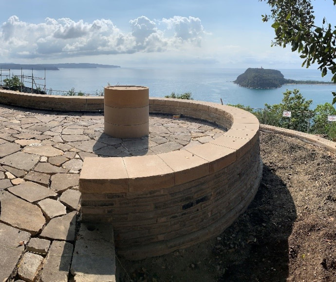 Sandstone retaining walls, including curved sandstone seating wall, at lookout with view over the water