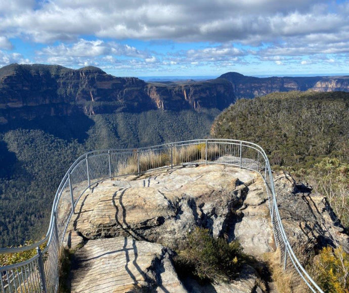 Rocky lookout over the valley with metal safety fence
