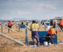 Workers set up solar panels at Moree Solar Farm. Moree, NSW