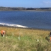 Two people planting trees on the foreshore of Tilba Tilba Lake
