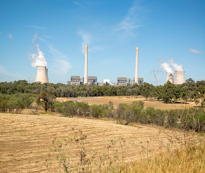 Muswellbrook Clean Air Project. Farming land and grasses in foreground with heavy industry in the background