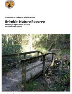 Cover page of a document titled "Brimbin Nature Reserve: Footbridge Replacement Review of Environmental Factors" by the NSW National Parks and Wildlife Service. The page features the NSW Parks & Wildlife Service logo at the top left, with a photograph below showing an old wooden footbridge in a forested area. The surrounding environment is lush with trees, bushes, and grass. The bottom of the page includes the website "environment.nsw.gov.au".